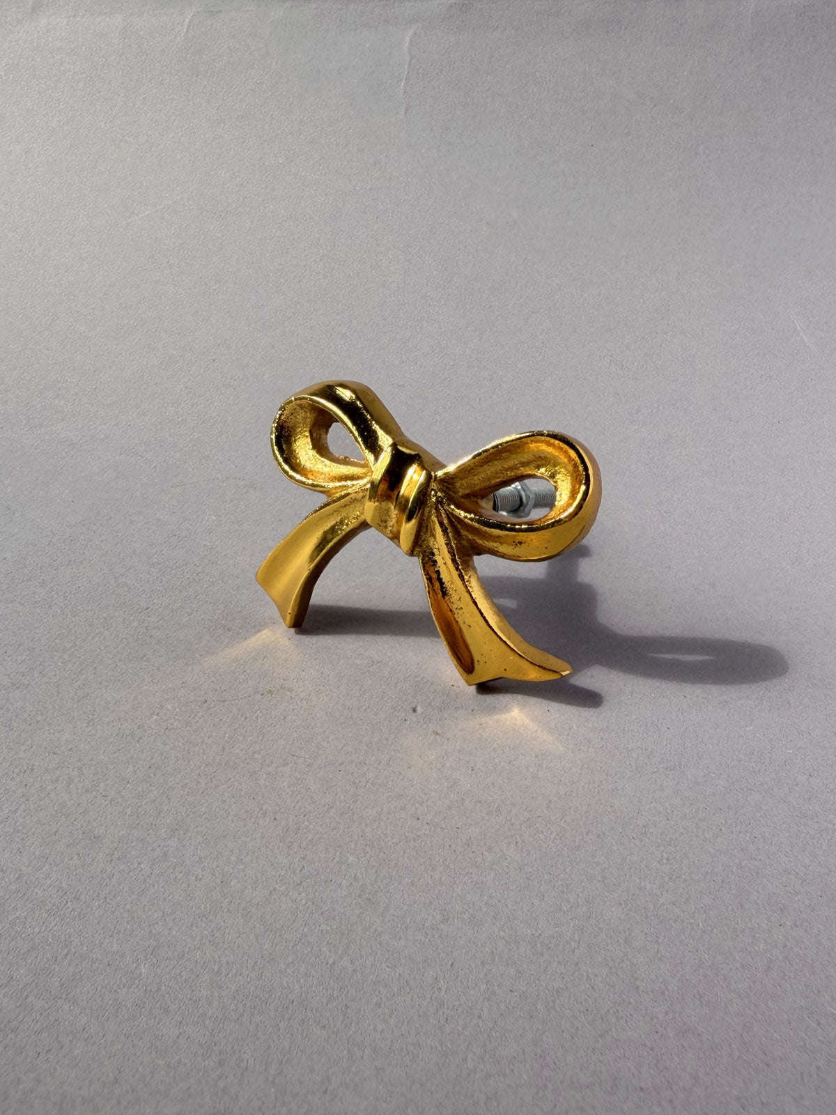 Cast iron knob gold bow