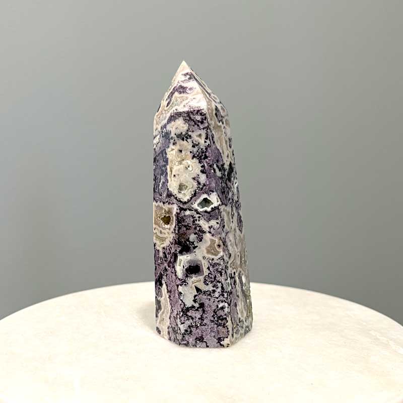 Purple mineral specimen tower