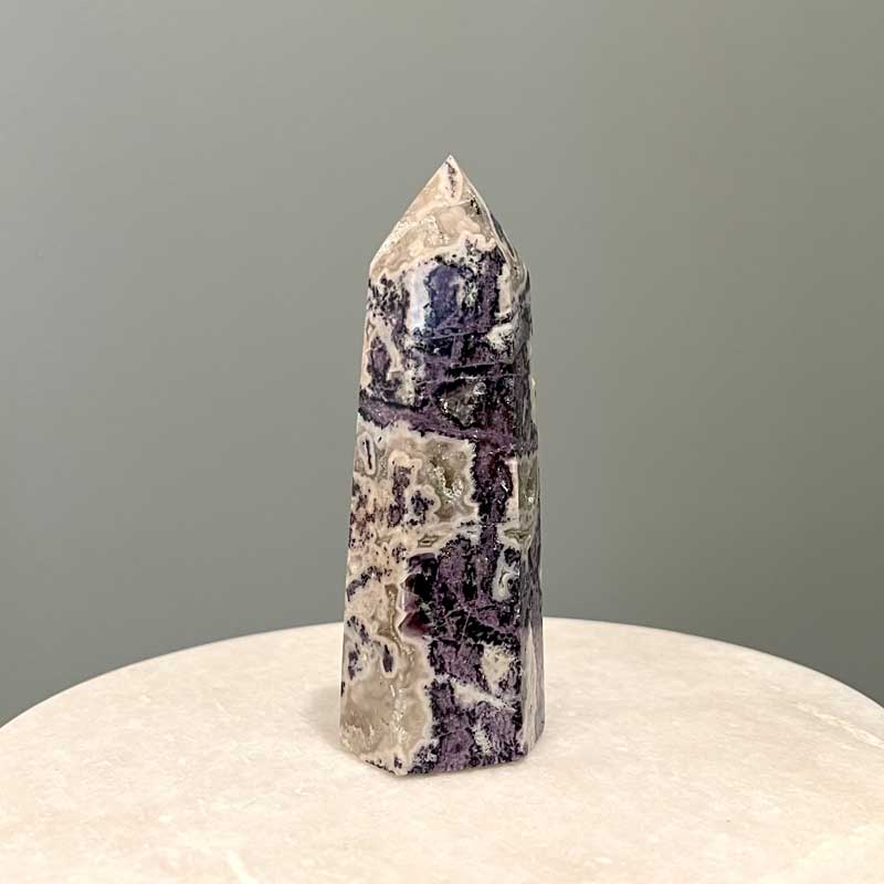 Purple mineral specimen tower