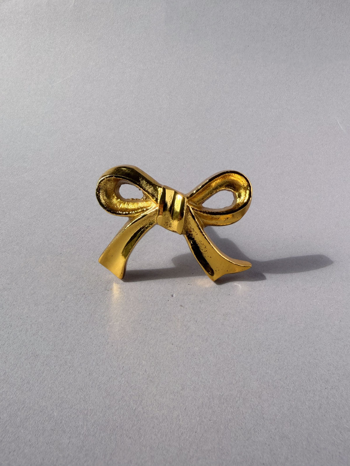 Cast iron knob gold bow